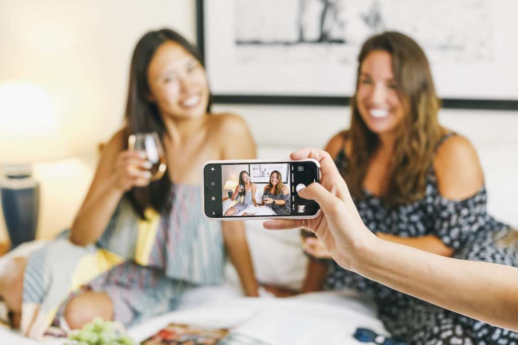 Girls taking photo in hotel room